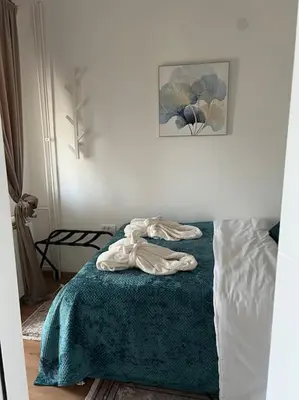 a bedroom with a bed with a towel on it at View in Zvezdara