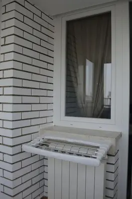 a window on a brick wall next to a door at View in Zvezdara