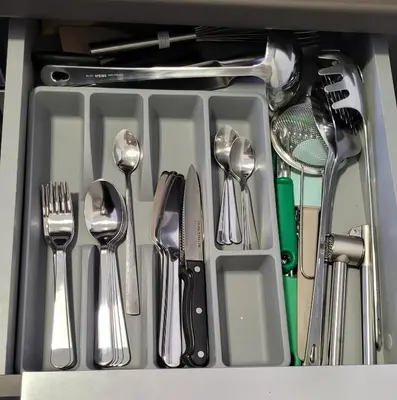 a tray of utensils in a drawer at Sanja, Old Town in Belgrade