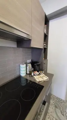 a kitchen with a black counter top in a room at Sanja, Old Town in Belgrade