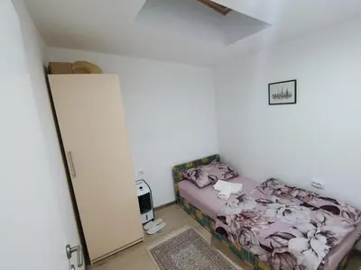 a small bedroom with a bed and a mirror at S Lux in Belgrade