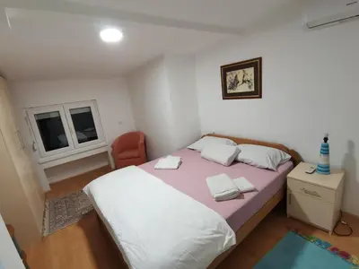 a bedroom with a bed with two towels on it at S Lux in Belgrade