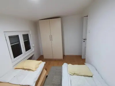a white room with two beds and a window at S Lux in Belgrade
