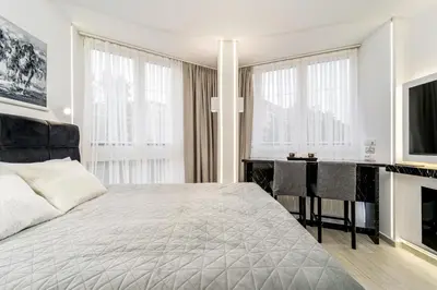 a bedroom with a large bed and a desk at New Urban Studio in Belgrade