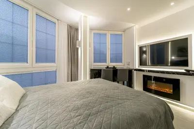 a bedroom with a bed and a tv and a fireplace at New Urban Studio in Belgrade