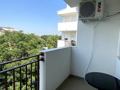 a balcony with a air conditioner on the wall at Apartman Peric in Ruma