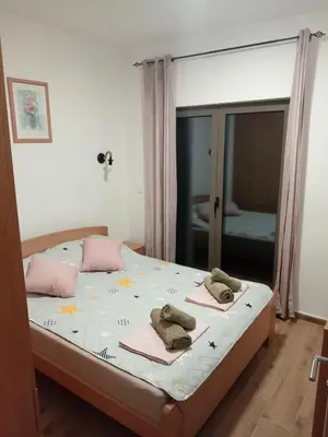a bedroom with a bed with two towels on it at La Casa Sofija in Nemenikuće