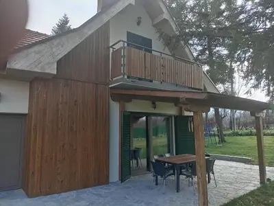a house with a deck and a table at La Casa Sofija in Nemenikuće