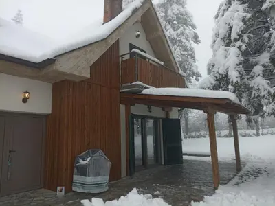 a house with a deck covered in snow at La Casa Sofija in Nemenikuće