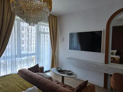a living room with a couch and a television at Beldorado Apartments - Belgrade Waterfront Luxury Designer Studio in Belgrade