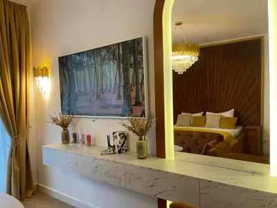 a bedroom with a bed and a large mirror at Beldorado Apartments - Belgrade Waterfront Luxury Designer Studio in Belgrade