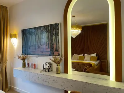 a living room with a mirror and a bed at Beldorado Apartments - Belgrade Waterfront Luxury Designer Studio in Belgrade