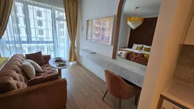 a living room with a couch and a large mirror at Beldorado Apartments - Belgrade Waterfront Luxury Designer Studio in Belgrade
