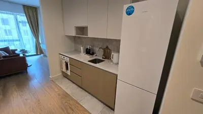 a kitchen with a sink and a refrigerator at Beldorado Apartments - Belgrade Waterfront Luxury Designer Studio in Belgrade