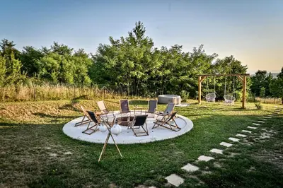 a group of chairs and a table in a yard at Smart glamp in Bukovik