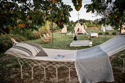 a swinging bed in a yard with a playground at Smart glamp in Bukovik