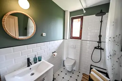 a bathroom with a sink and a toilet and a mirror at Smart glamp in Bukovik