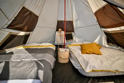a room with two beds in a tent at Smart glamp in Bukovik
