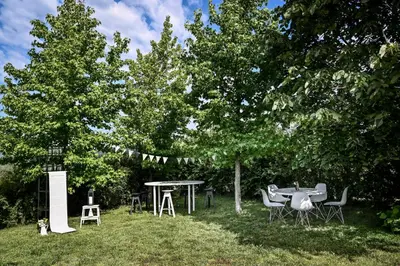 a picnic table and chairs in a field with trees at Smart glamp in Bukovik