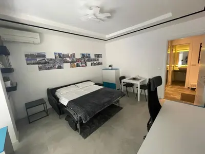 a bedroom with a bed and a table and a dining room at The Style, apartman sa parkingom in Belgrade