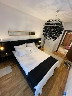 a large bed in a room with wine racks at Lux Tea Pancevo in Pančevo