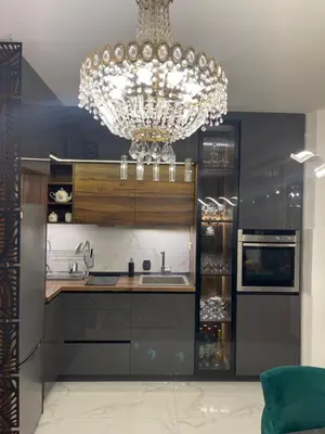 a kitchen with a chandelier and a sink and a counter at Lux Tea Pancevo in Pančevo