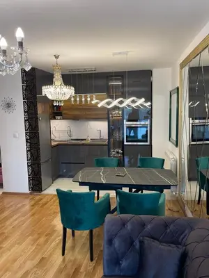a dining room and kitchen with a table and chairs at Lux Tea Pancevo in Pančevo