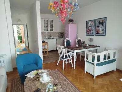 a kitchen and living room with a table and chairs at Gold Apartments in Belgrade