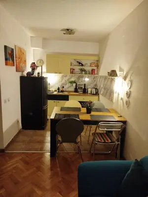 a kitchen with a table and chairs in a room at Gold Apartments in Belgrade