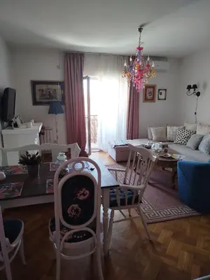 a living room with a table and a dining room at Gold Apartments in Belgrade