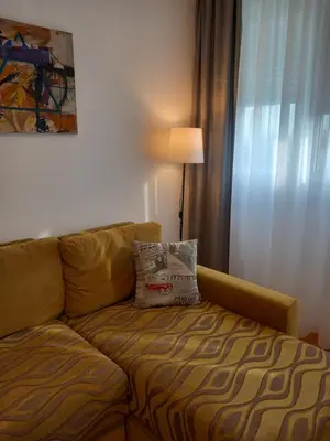 a couch in a living room with a lamp at Pariske noći in Belgrade