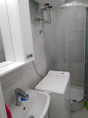 a small bathroom with a toilet and a sink at Pariske noći in Belgrade