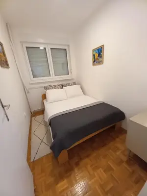 a small bedroom with a bed in a room at Pariske noći in Belgrade
