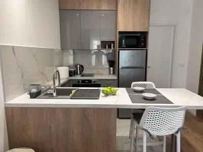 a kitchen with a counter with a laptop on it at V Park Lux Apartman in Belgrade