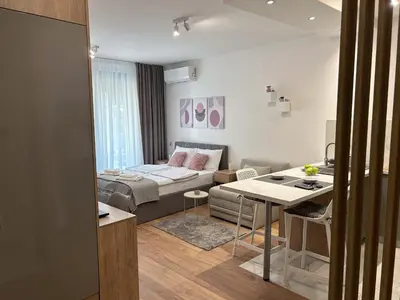 a living room with a couch and a table at V Park Lux Apartman in Belgrade