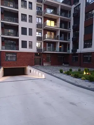 an empty parking lot in front of a building at V Park Lux Apartman in Belgrade