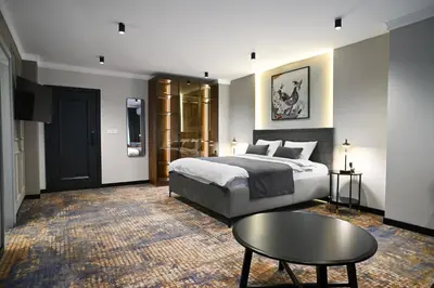 a hotel room with a bed and a table at Black Gallo Residences in Belgrade
