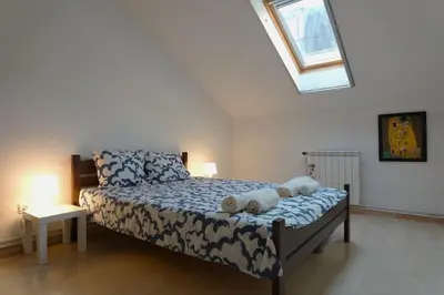 a bedroom with a bed with two pillows on it at Vracar Historical in Vračar (historical)
