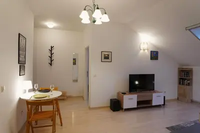 a living room with a table and a television at Vracar Historical in Vračar (historical)