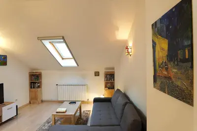 a living room with a couch and a skylight at Vracar Historical in Vračar (historical)