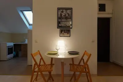 a table and chairs in a living room with a window at Vracar Historical in Vračar (historical)