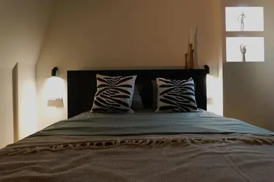 a bedroom with a large bed with two pillows at Belgrade Cloud in Belgrade