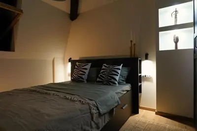 a bedroom with a bed with two pillows on it at Belgrade Cloud in Belgrade