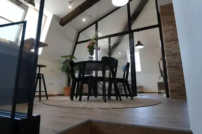 a dining room with black chairs and a table at Belgrade Cloud in Belgrade