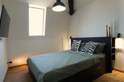 a bedroom with a large bed with pillows on it at Belgrade Cloud in Belgrade