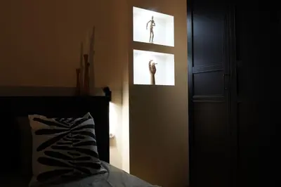 a bedroom with two pictures of a person on the wall at Belgrade Cloud in Belgrade