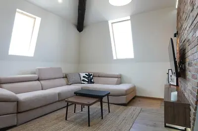 a living room with a couch and a table at Belgrade Cloud in Belgrade