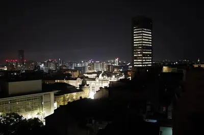 a city skyline at night with a tall building at Belgrade Cloud in Belgrade