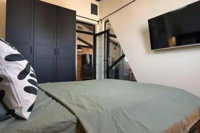 a bedroom with a bed and a flat screen tv at Belgrade Cloud in Belgrade