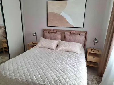 a bedroom with a bed with a white comforter at Apartment Belgrade Waterfront LUX -Libera 413 in Belgrade